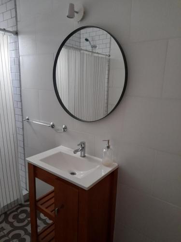 a bathroom with a sink and a mirror on the wall at Arenales 1 in Azul
