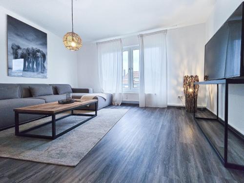 a living room with a couch and a table at Alpha Apartments in Essen