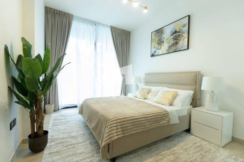 a bedroom with a bed and a large window at Amazing Pool View In 1br Apt - Jvc Dubai in Dubai