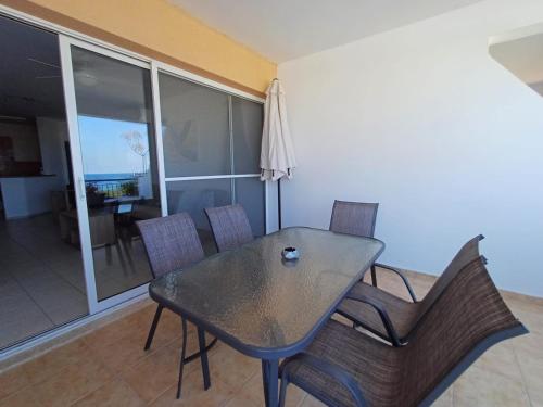 Una mesa de comedor y sillas en una sala de estar. en Kings Palace - spacious 2-bed with sea views and large patio, en Pafos