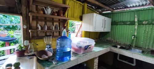 a kitchen counter with a bottle of water on it at La Loma Camping in Higuey