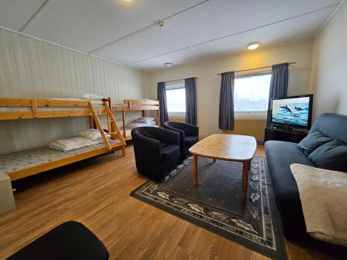 a living room with a couch and a bunk bed at Lofotr Overnatting in Bøstad