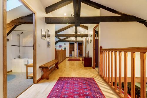 a hallway with a bench and a rug at The Coach House - Avec piscine partagée in Osserain-Rivareyte