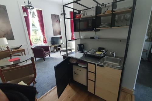 a kitchen with a counter and a sink in a room at Clairville : Georgian Suite - Central Ross-on-Wye in Ross on Wye