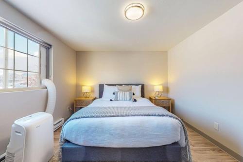 a bedroom with a large bed with two lamps at Modern Lofts at Aria 7 in Kalispell
