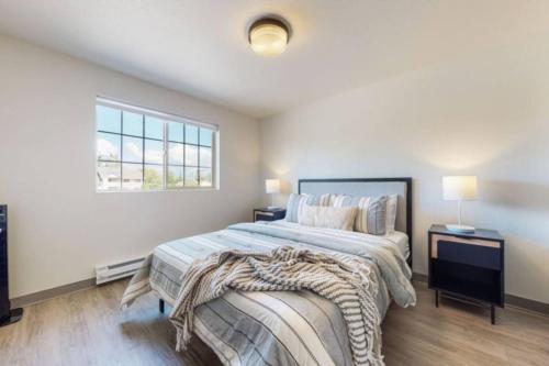 a bedroom with a large bed and a window at Modern Lofts at Aria 6 in Kalispell