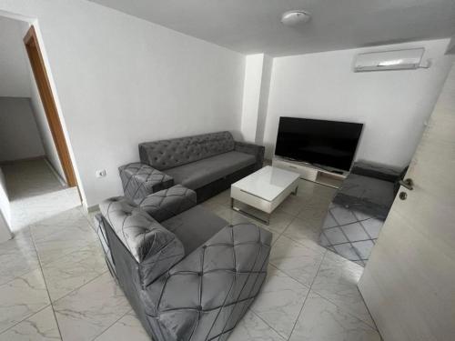 a living room with a couch and a tv at Melek in Medulin
