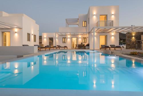 a villa with a swimming pool in front of a house at Beautiful Paros Villa - 1 Bedroom - Villa Rock - Private Jacuzzi and Garden View - Naousa in Livadia