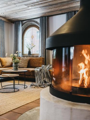 a living room with a couch and a fireplace at VAYA Seefeld inklusive Seefeld Gästekarte in Seefeld in Tirol