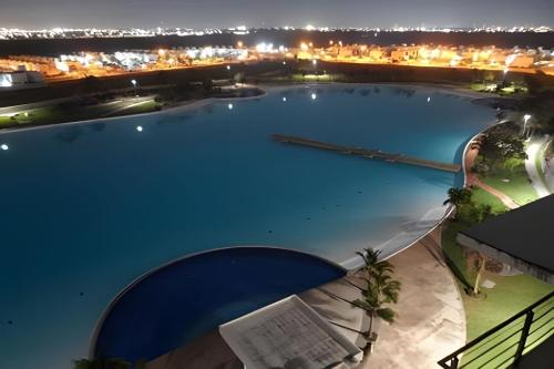 a large swimming pool with a city in the background at Dream Lagoons Veracruz in Veracruz