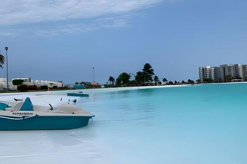 a swimming pool with two boats in the water at Dream Lagoons Veracruz in Veracruz