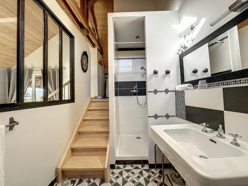 a bathroom with a sink and a shower at Antre Lacs in Saint-Girod