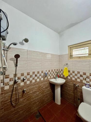 a bathroom with a sink and a shower at Breeze Blows- Solitude Holiday Home in Matara