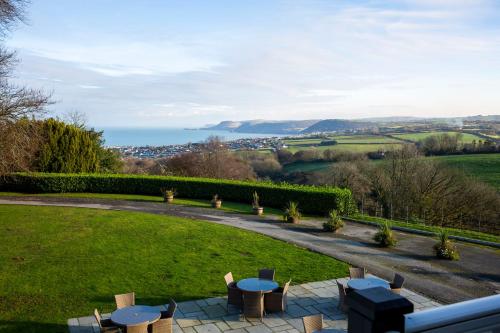 a view of a garden with tables and chairs at The Penrallt Country House Hotel in Aberporth