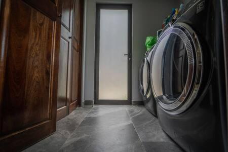 a laundry machine in a room with a door at Modern Villa Overlooking Macal River Valley in Benque Viejo del Carmen