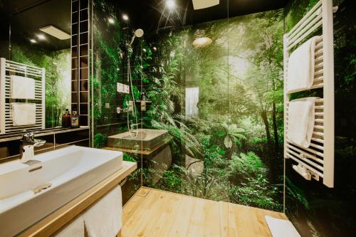 a bathroom with a shower with a green wallpaper at Rioca Frankfurt Posto 7 in Frankfurt/Main