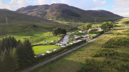 an aerial view of a village in the mountains at Glengoulandie Glamping in White Bridge