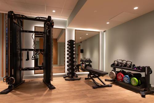 a room with a gym with a mirror and weights at The Address Glasgow in Glasgow