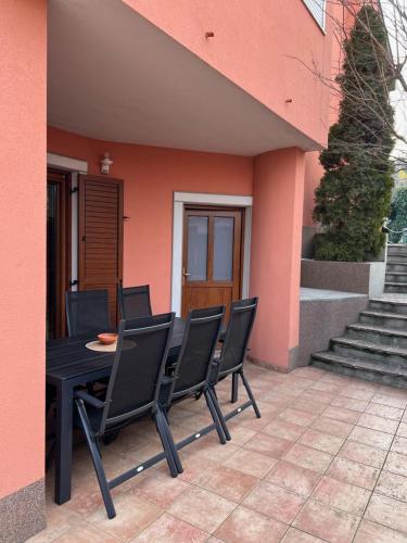 a patio with a table and chairs in front of a house at Lazar TERRACE Apartment in Izola