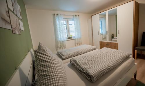a bedroom with two beds and a mirror at Haus Avallon in Cochem