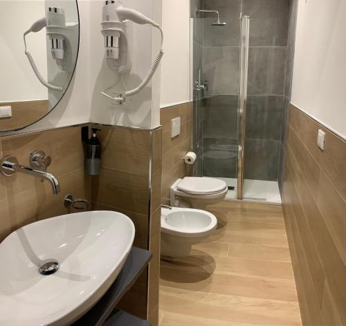 a bathroom with a toilet and a sink and a shower at LAME 46 ROOMS in Bologna