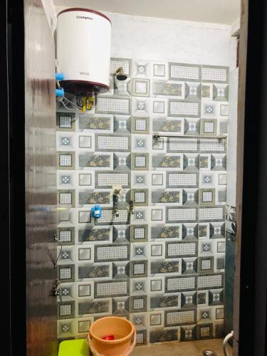 a wall covered in gray and white tiles at Krishna home inn. in Mathura