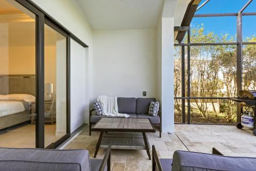 a living room with a couch and a bed at Central inland home with pool, spa and table tennis in Marco Island