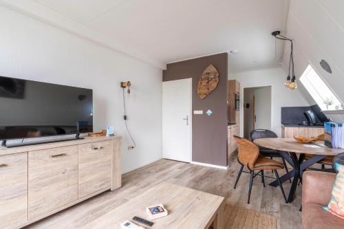 a kitchen and living room with a table and chairs at Anna 222 in De Koog