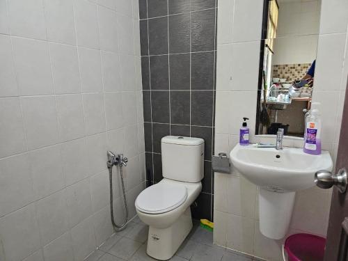 a bathroom with a toilet and a sink at The School Homestay in Putrajaya