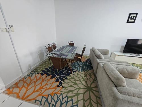 a living room with a couch and a table and chairs at The School Homestay in Putrajaya
