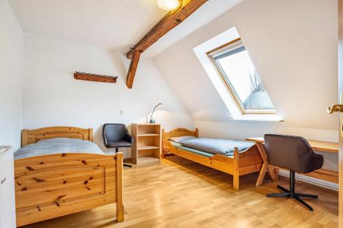 a bedroom with a bed and a desk and a window at Monteurzimmer in Bad Bodenteich