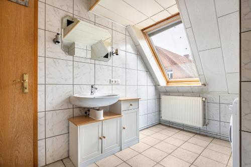 a bathroom with a sink and a window at Monteurzimmer in Bad Bodenteich