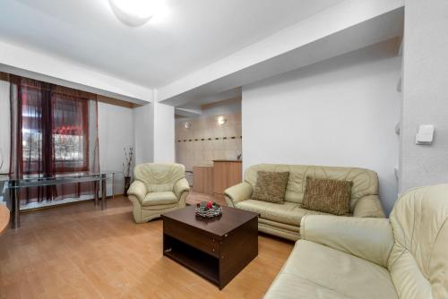 uma sala de estar com um sofá e uma mesa em Central Apartament Predeal Nr 1 em Predeal