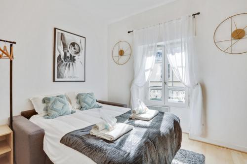 a bedroom with a bed with towels on it at 247 Suite Milan - Superb apartment in Paris. in Paris