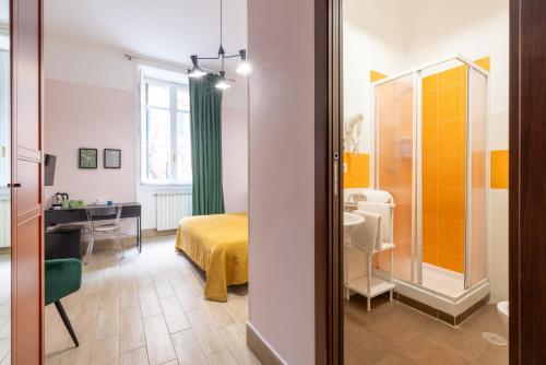 a room with a bed and a desk and a mirror at Domus Castroni Scipioni in Rome