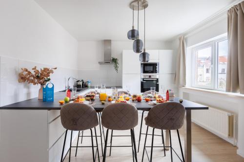 a kitchen with a island with bar stools at Sweet Inn - Michel Ange in Brussels