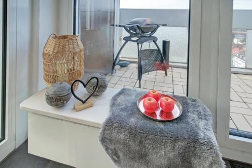 a plate of fruit on a table with a camera at Das Penthouse - Jacuzzi - BBQ - Dachterrasse in Karlsruhe