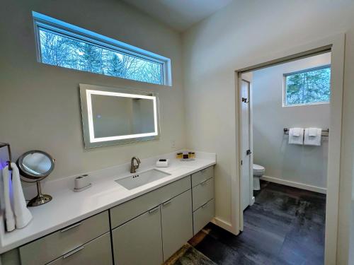 a bathroom with a sink and a window at 1A Maple Lodge Stunning luxury Scandinavian style home with great views in Bethlehem