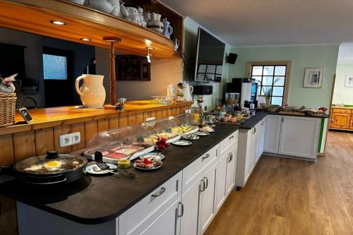 a kitchen with a counter with food on it at Pension Anni in Sanitz