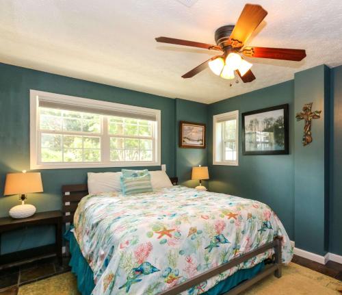 a bedroom with a bed and a ceiling fan at House #14 Pelican Sunrise (no pets) Lake View in Centre