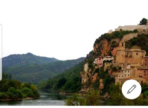 a mountain with a town on top of a river at Casa de Danann in Rasquera