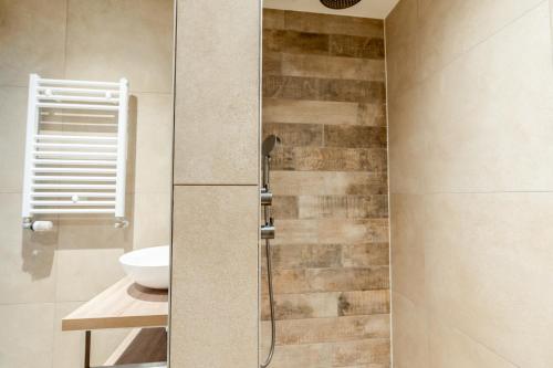 a bathroom with a shower with a toilet and a sink at Anna 224 in De Koog