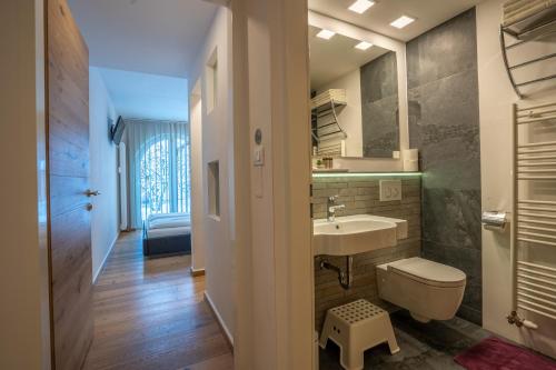 a bathroom with a sink and a toilet at TEMPFER Apartments & Rooms with new WELLNESS in Rateče