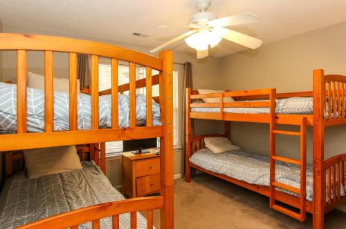two bunk beds in a room with a ceiling fan at House #17 On The Rocks (no pets) Lake View in Centre