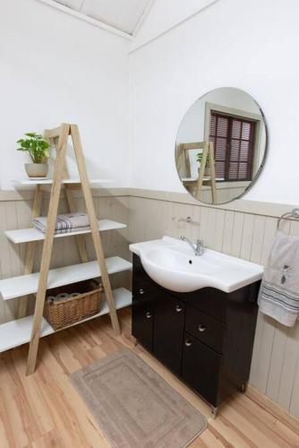 a bathroom with a sink and a mirror at Lala Lapa Self Catering Accomodation in Nelspruit