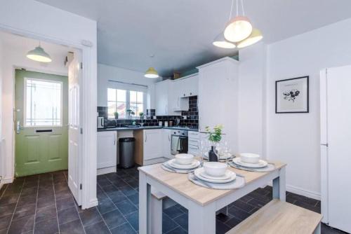 a kitchen with a table with plates on it at The Olive Suite in Clock Face