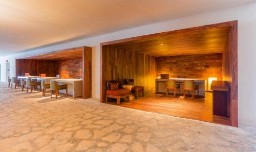 a dining room with tables and chairs and a bar at Presidente InterContinental Cozumel Resort & Spa by IHG in Cozumel