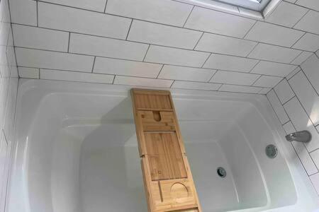 a bath tub with a wooden frame in a bathroom at Steps from Journeyman in Downtown Valparaiso in Valparaiso