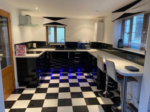 a kitchen with a black and white checkered floor at The Annex in Bristol