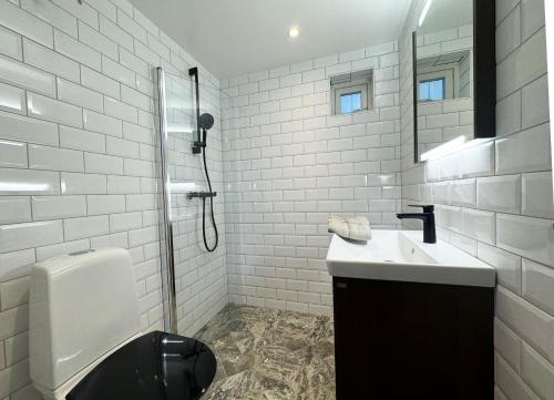 a bathroom with a toilet and a sink and a mirror at A charming little cottage in beautiful Hunnebostrand in Hunnebostrand
